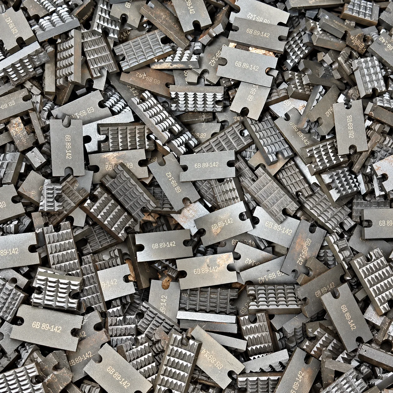 Replacement tong dies showing gripping teeth and component markings
